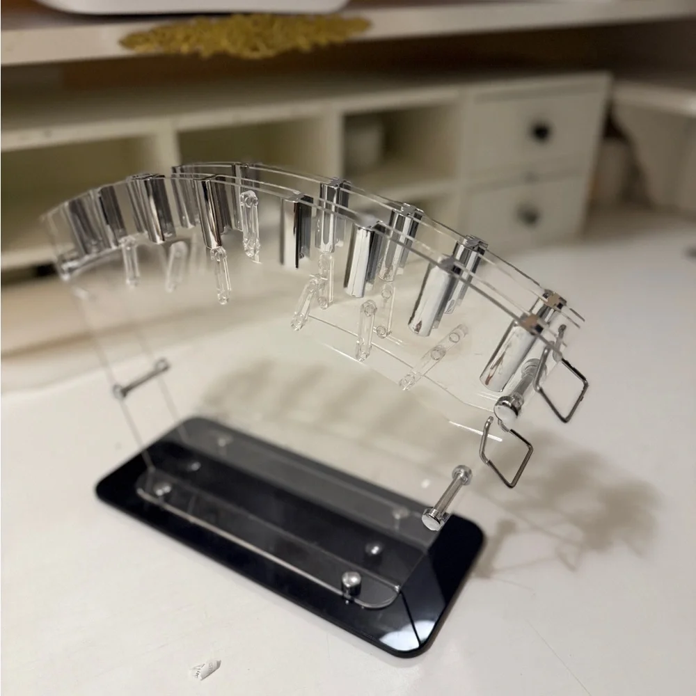 clear acrylic knife block or stand, designed to hold and display kitchen knives.